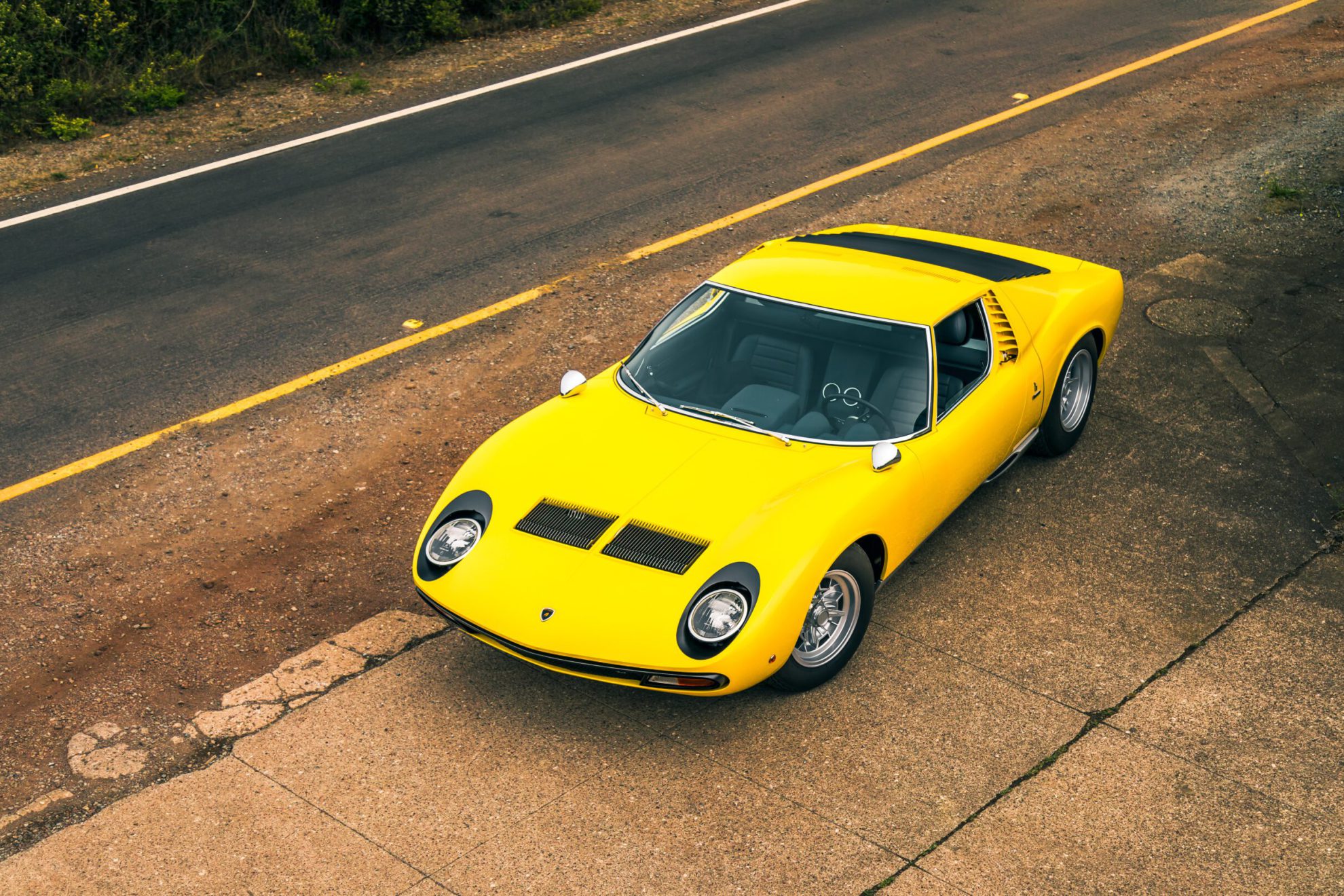 San Fran, CA, USA
11/2/2021
Yellow Lamborghini Miura parked on the side of the road with a yellow line on the road